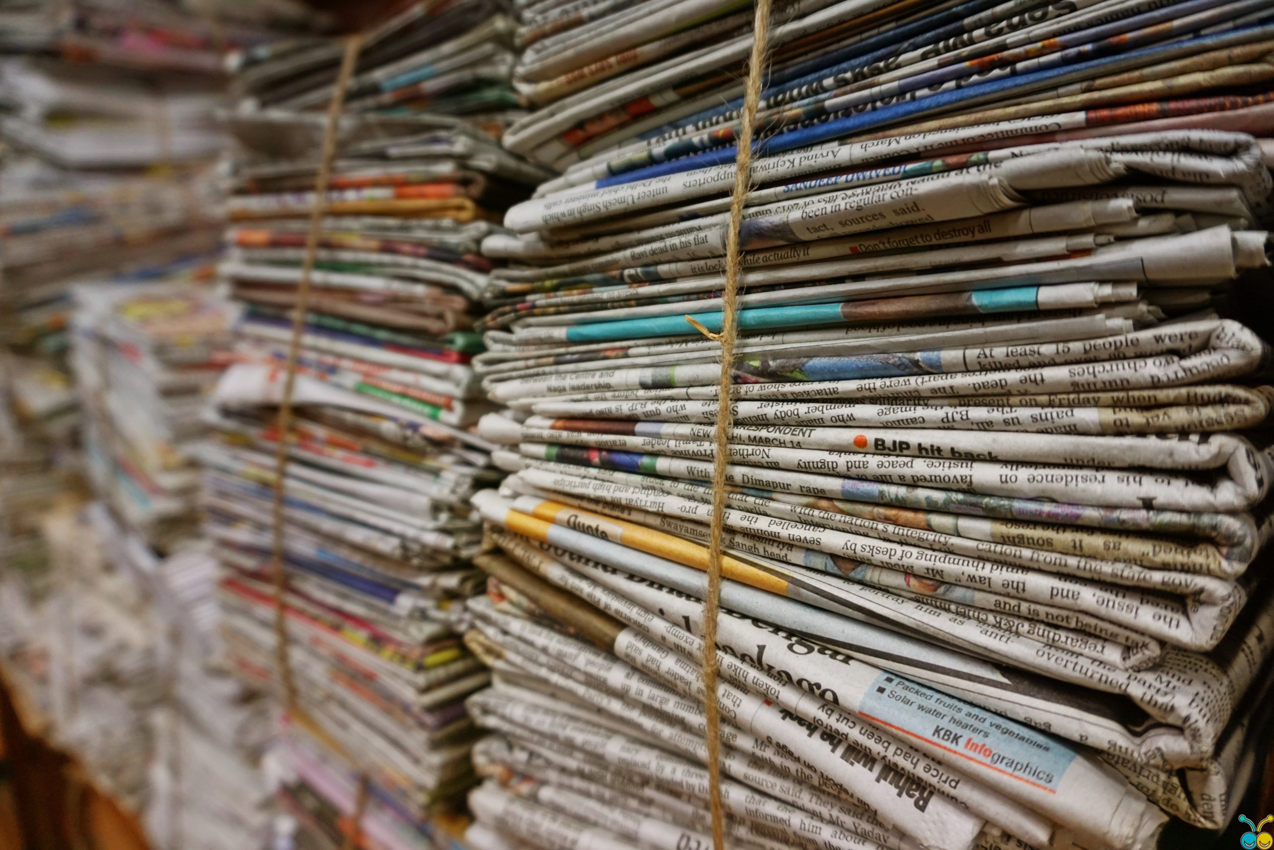 Stack of newspapers that you will earn coverage in by following the advice in this blog.