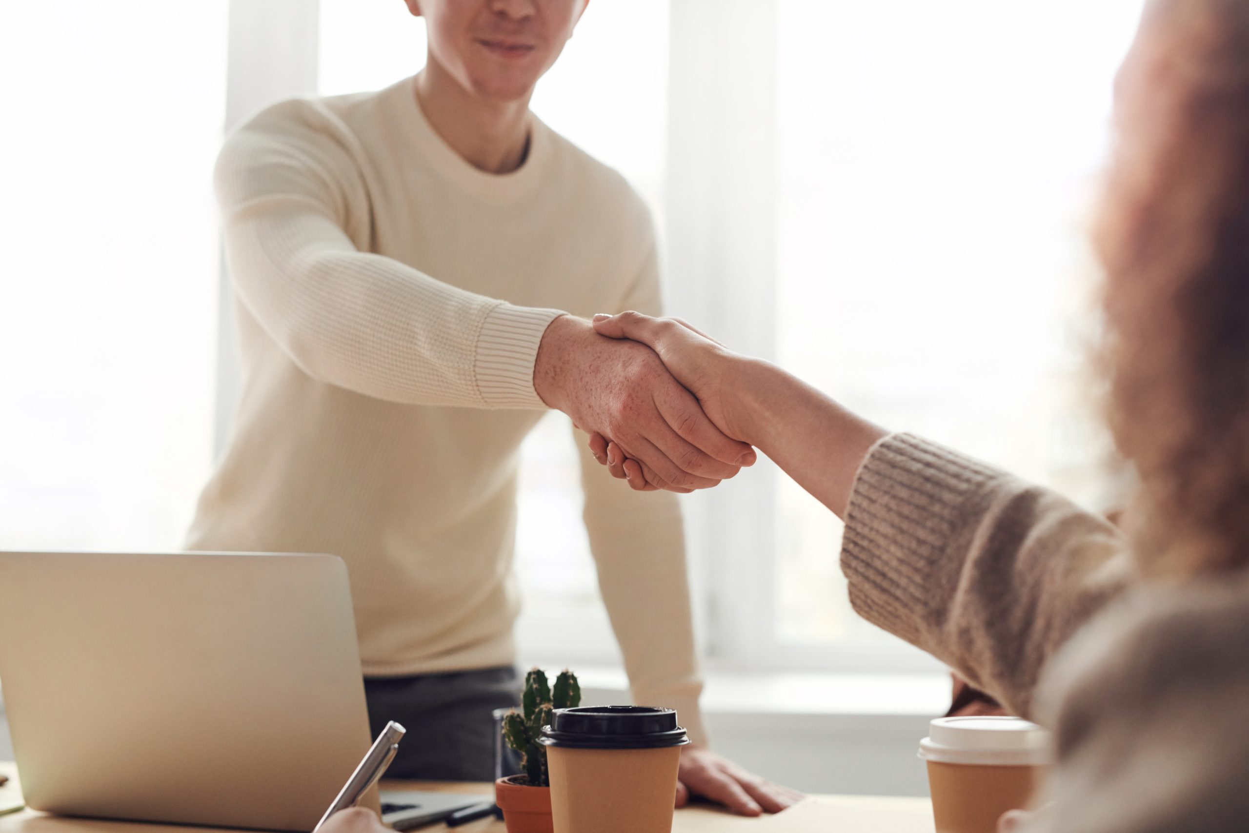 People shaking hands during a business meeting